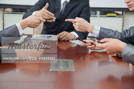 Businesspeople Making Gestures During Business Meeting