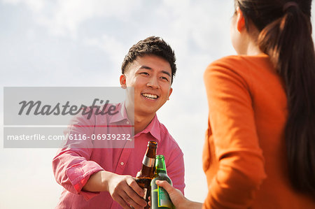 Friends Toasting Each Other on a Rooftop