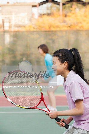 Mother and daughter playing tennis