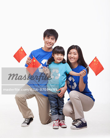 Family Portrait, one child with parents, waving Chinese flags, studio shot