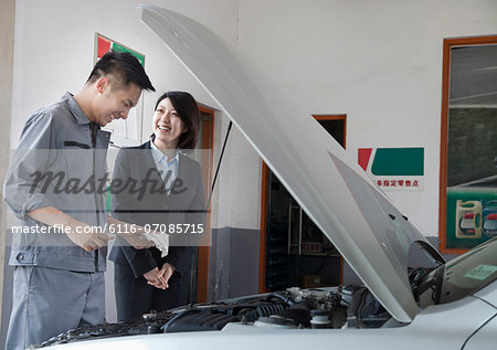 Mechanic Chatting and Laughing with Customer