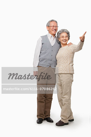 Senior couple pointing