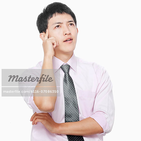 Young man with hand on face thinking