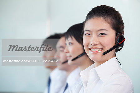 White Collar Workers in a row with headsets