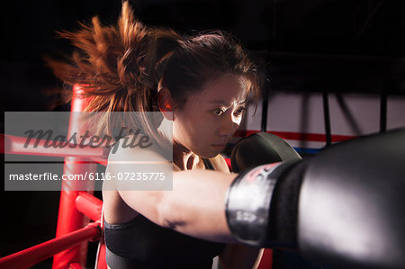 Close up of female boxer throwing a punch, hair in motion