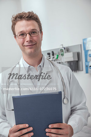 Portrait of smiling doctor holding a clipboard