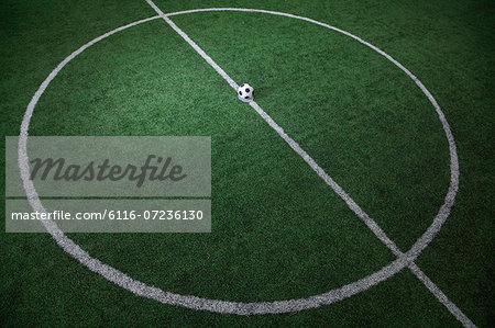 Soccer field with soccer ball on the line, high angle view