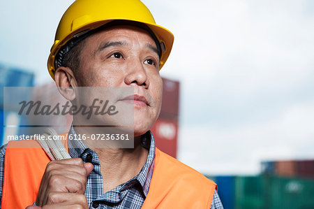 Portrait of proud worker in protective workwear in a shipping yard