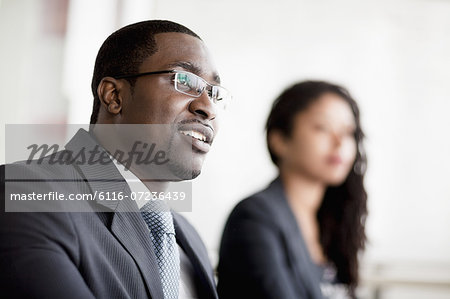 Smiling businessman listening at a business meeting