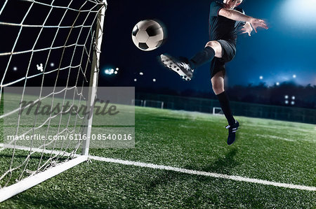 Athlete Kicking Soccer Ball Into A Goal Stock Photo Masterfile Premium Royalty Free Code 6116