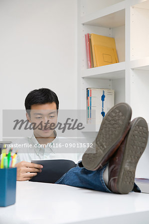 Man with feet on desk