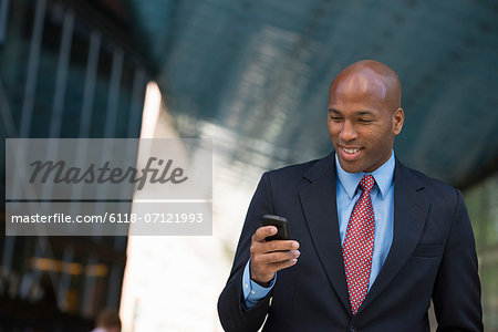 Business People. A Man In A Suit Checking His Phone.
