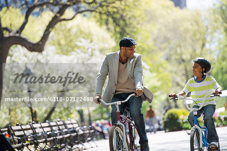 Bicycling And Having Fun. A Father And Son Side By Side. Bicycling And Having Fun. A Father And Son Side By Side.
