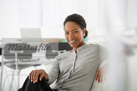 Business. A Woman Seated On The Sofa Looking Relaxed.