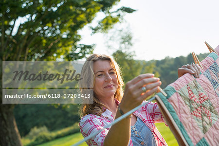 A woman hanging laundry on the washing line, in the fresh air.