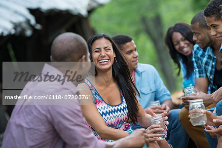 A group of men and women outdoors enjoying themselves. A group of men and women outdoors enjoying themselves.