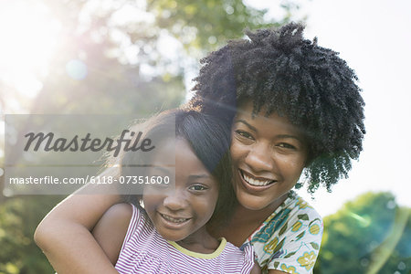 A young woman and a child hugging.