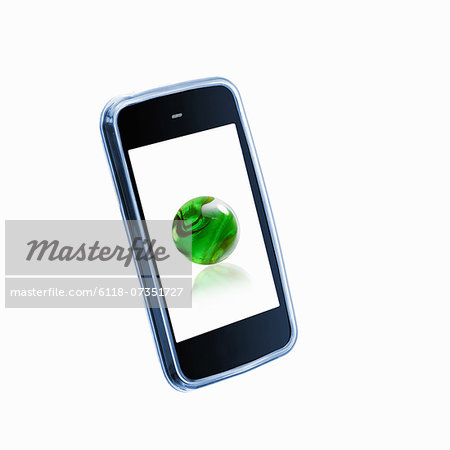 A small handheld communication device or phone with a green globe or sphere on the screen.