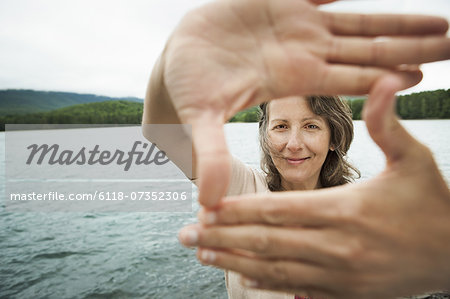 A woman in open countryside, by a mountain lake. A woman in open countryside, by a mountain lake.