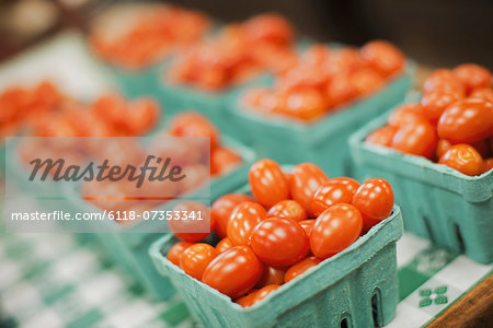 A farm stand. Green boxes of tomatoes. A farm stand. Green boxes of tomatoes.