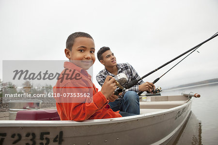 A day out at Ashokan lake. Two boys fishing from a boat. - Stock