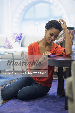 Woman relaxing at home using smartphone