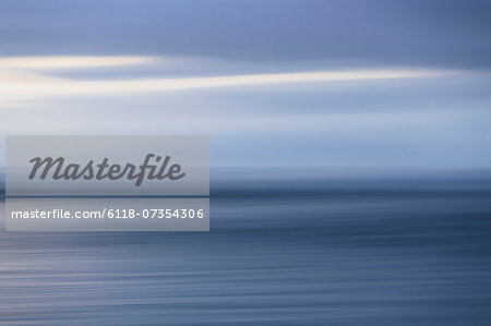 The sea and sky over Puget Sound in Washington, USA. The horizon with light cloud layers above. The sea and sky over Puget Sound in Washington, USA. The horizon with light cloud layers above.