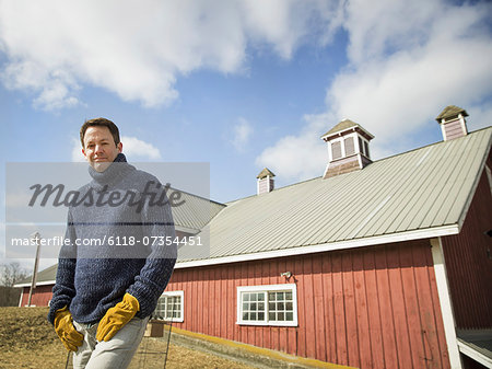 An Organic Farm in Winter in Cold Spring, New York State. A man working outdoors on the farm.