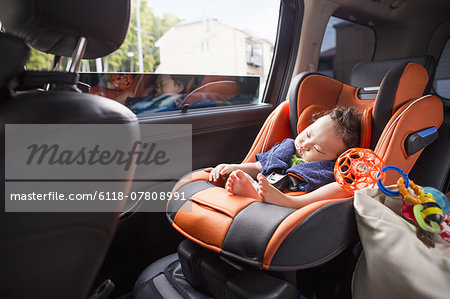 A mother and her young baby boy in a car.