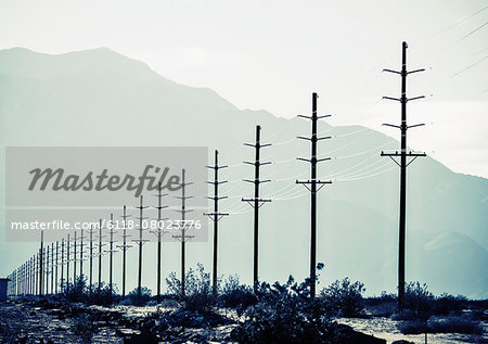 Power lines reaching into the distance, with a mountain backdrop.