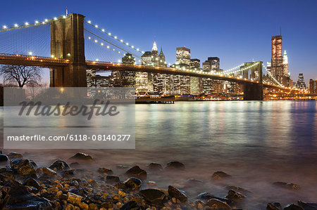 Night view towards Manhattan from Brooklyn, with the Brooklyn Bridge spanning the East River.