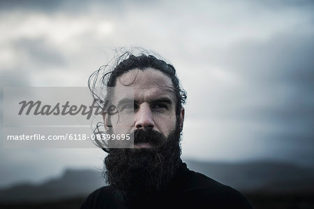 A man with black hair, a full beard and moustache. A man with black hair, a full beard and moustache.