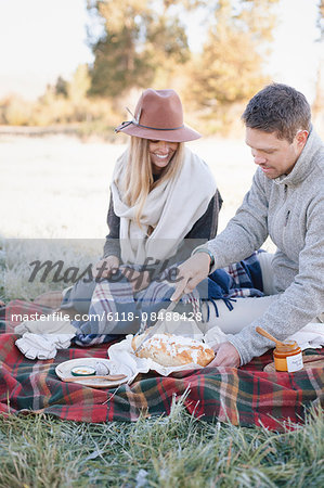 A couple sitting having a picnic.