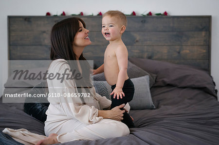 A woman playing with her young son.