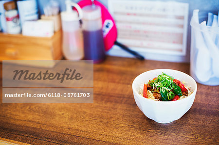 A ramen noodle shop. A bowl of fresh made ramen noodles with vegetables and meat.