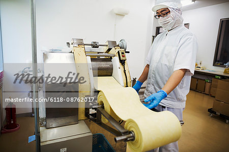 Worker in a factory producing Soba noodles