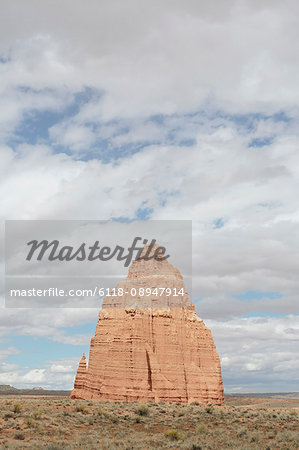 The Temple of the Moon rock formation in Cathedral Valley in the Capitol Reef National Park, monolith of earthy, buff-pink Entrada Sandstone rising from the plain.