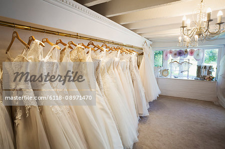 Rows of wedding dresses on display in a specialist wedding dress shop. Bridal Boutique.