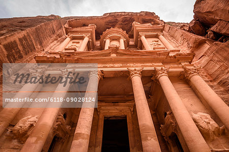 Low angle exterior view of the rock-cut architecture of Al Khazneh or The Treasury at Petra, Jordan.