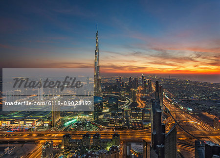 Cityscape of Dubai, United Arab Emirates at dusk, with the Burj Khalifa skyscraper in the distance.