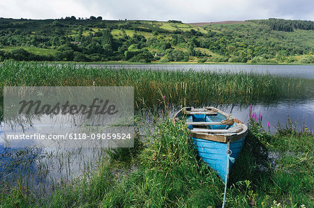 Blue wooden rowboat lying on the shore of Glenade Lake, Glenade, County Leitrim, Ireland.