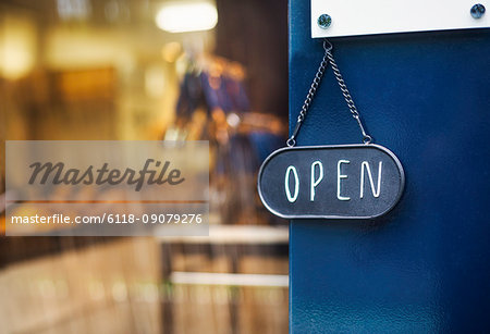 Close up of open sign on glass door to a bakery. Close up of open sign on glass door to a bakery.