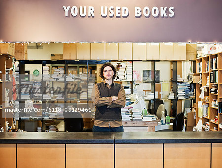 Portrait of a Caucasian male employee of a bookstore working in the Used Books section of the store.