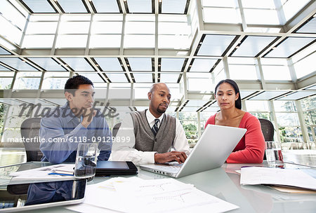 Mixed race team of business people at a table in a business centre.