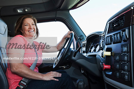 Relaxed Caucasian Truck Driver Seating on the Ground and Support His Back  on the Semi Truck Wheel Stock Photo - Alamy