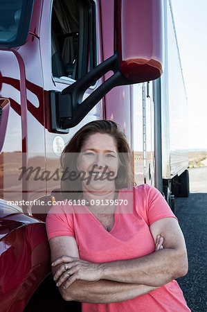 Portrait of a Caucasian woman driver and her commercial truck.