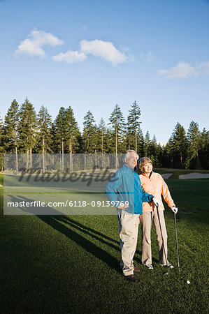 Senior golfing couple on the golf course.