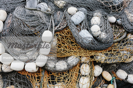 Fishing nets and floats, commercial fishing equipment in a heap on