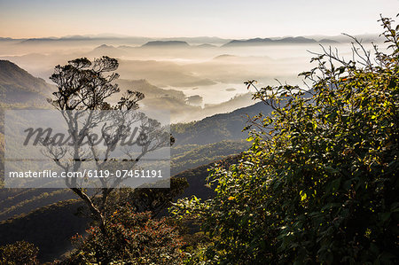 Misty sunrise view of mountains on the climb up Adam's Peak (Sri Pada) in the Central Highlands of Sri Lanka, Asia