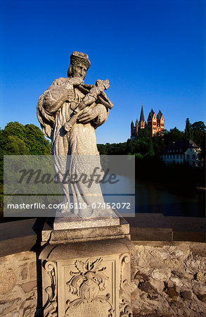 Statue on the Old Lahn-Bridge and a Cathedral in Limburg,  Germany
